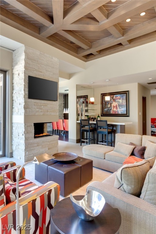 living area featuring recessed lighting, coffered ceiling, beamed ceiling, and a stone fireplace