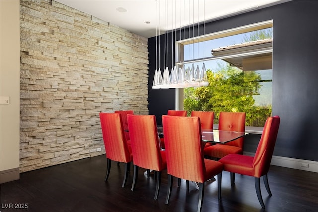 dining area featuring wood finished floors and baseboards