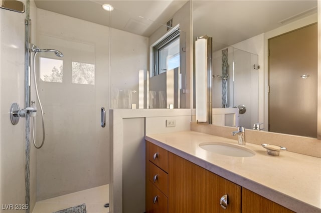 full bath with a stall shower and vanity