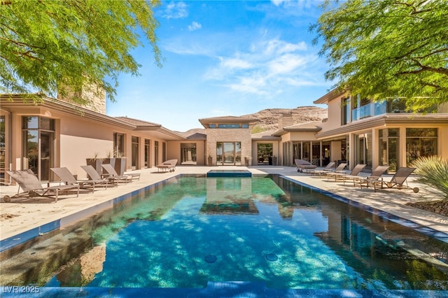 outdoor pool with a patio area