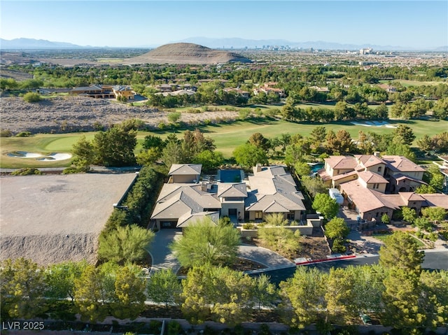 drone / aerial view with golf course view, a residential view, and a mountain view