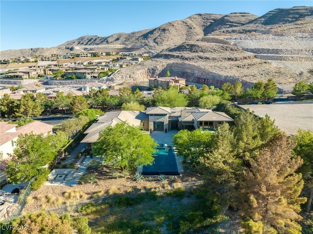 birds eye view of property featuring a mountain view