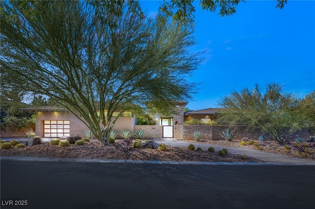 view of front facade featuring a fenced front yard and stucco siding