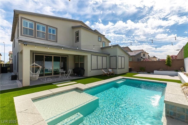 back of property featuring a fenced backyard, a fenced in pool, a patio, and stucco siding