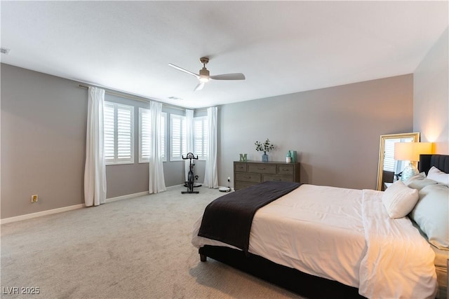 bedroom with baseboards, visible vents, a ceiling fan, and light colored carpet