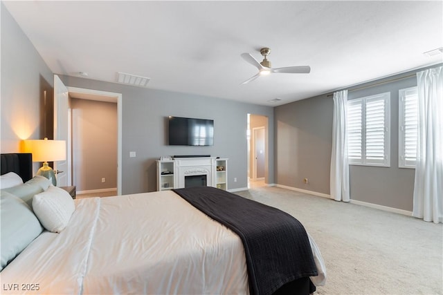 bedroom featuring carpet, visible vents, a fireplace, and baseboards