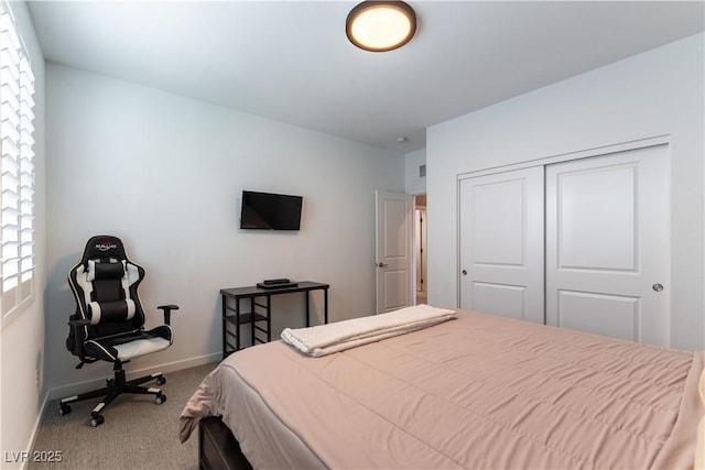 bedroom with carpet floors, a closet, and baseboards