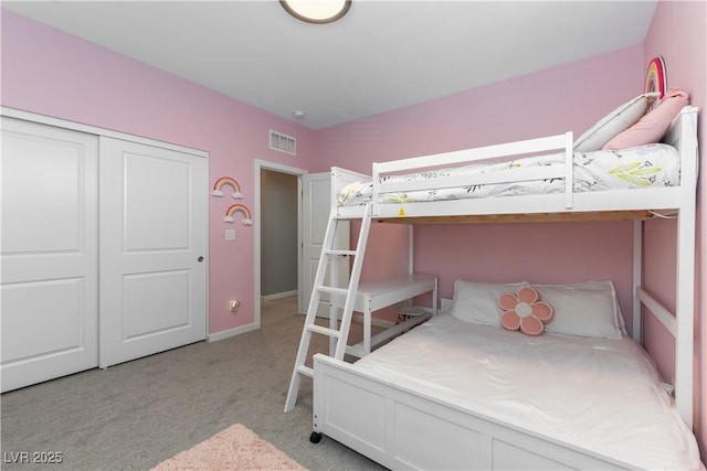 bedroom featuring light colored carpet, a closet, and visible vents