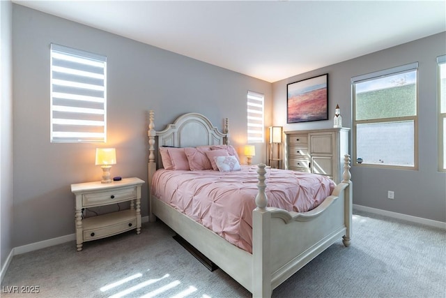 bedroom with carpet, multiple windows, and baseboards