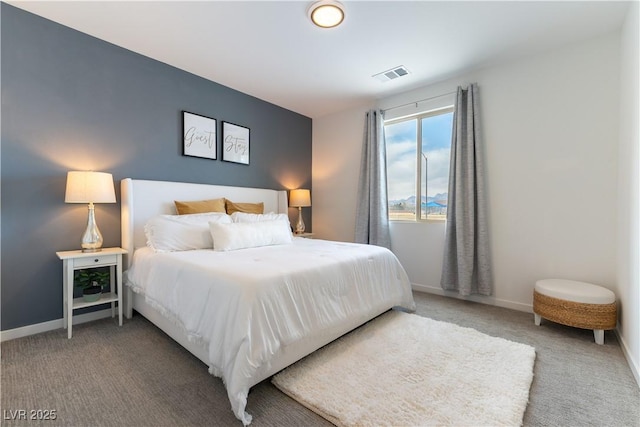 carpeted bedroom with visible vents and baseboards