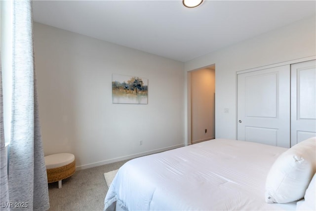 bedroom with a closet, carpet flooring, and baseboards