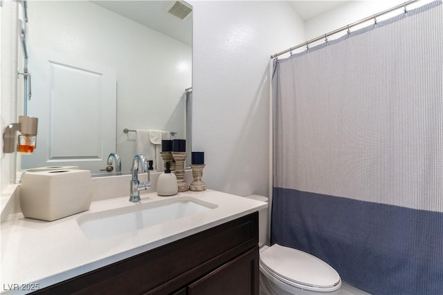 bathroom featuring toilet, curtained shower, vanity, and visible vents