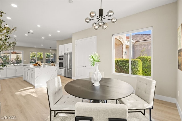 dining area with baseboards, light wood-type flooring, visible vents, and recessed lighting