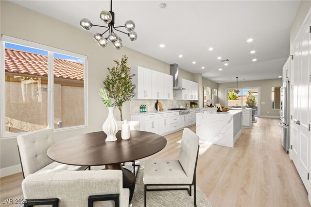 dining area with a chandelier, recessed lighting, visible vents, baseboards, and light wood-type flooring