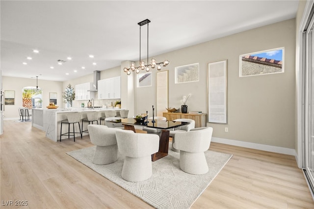 dining area featuring light wood-style floors, recessed lighting, and baseboards