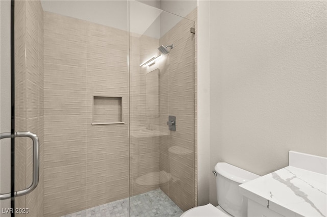 full bath with toilet, a shower stall, and vanity