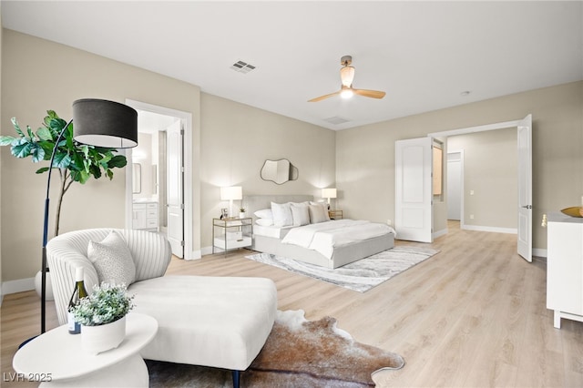 bedroom with baseboards, visible vents, connected bathroom, and light wood finished floors