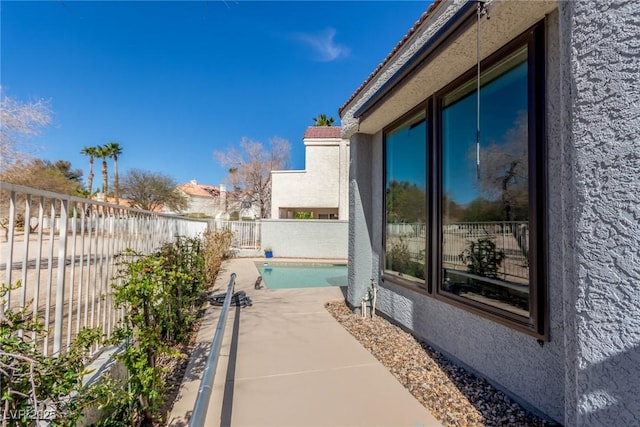 view of home's exterior with a fenced backyard, a patio, and stucco siding