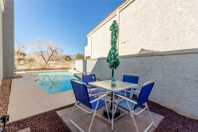 view of swimming pool featuring a fenced backyard, outdoor dining area, a fenced in pool, and a patio