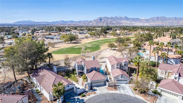 drone / aerial view with a residential view, a mountain view, and golf course view