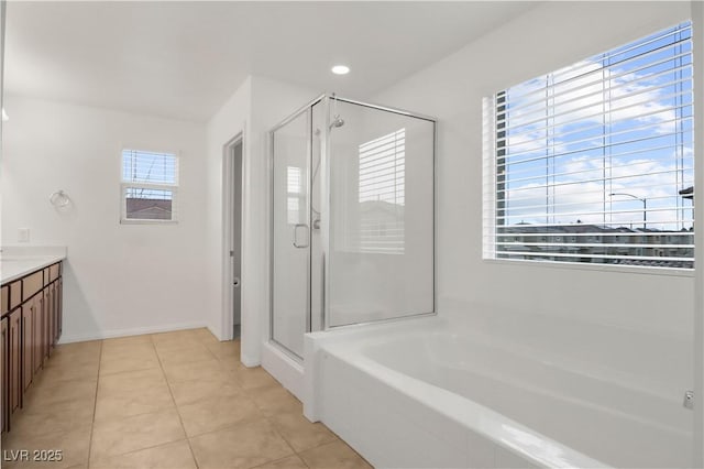 full bathroom with a stall shower, tile patterned flooring, a garden tub, and vanity