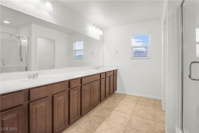 bathroom featuring double vanity, tile patterned flooring, a sink, and a shower with door