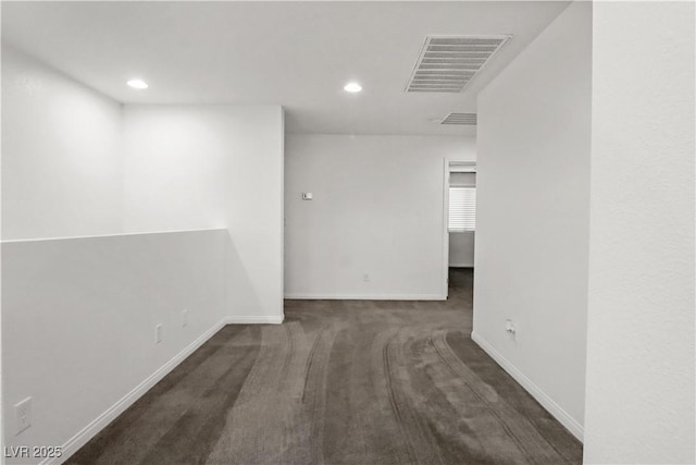 carpeted spare room with recessed lighting, visible vents, and baseboards