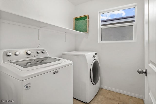 clothes washing area featuring laundry area, independent washer and dryer, baseboards, and light tile patterned floors