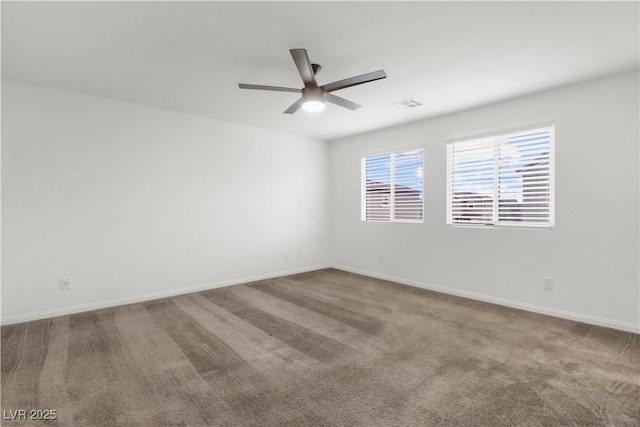 unfurnished room featuring baseboards, visible vents, ceiling fan, and carpet flooring