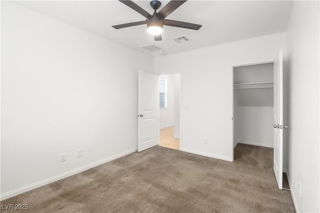 unfurnished bedroom featuring baseboards, a closet, visible vents, and carpet flooring