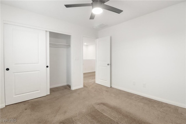 unfurnished bedroom featuring ceiling fan, a closet, carpet, and baseboards