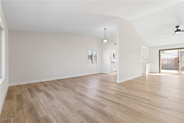 unfurnished living room with light wood-style floors, ceiling fan, high vaulted ceiling, and baseboards