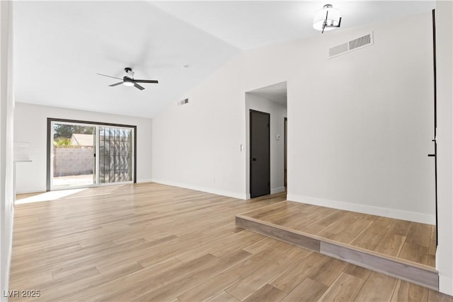 unfurnished room featuring vaulted ceiling, ceiling fan, visible vents, and light wood-style floors