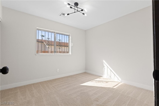 unfurnished room with carpet flooring, visible vents, and baseboards