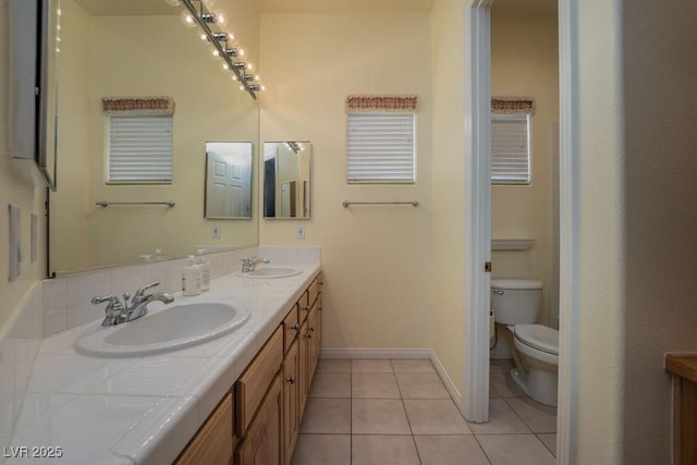 full bathroom featuring tile patterned flooring, a sink, toilet, and double vanity