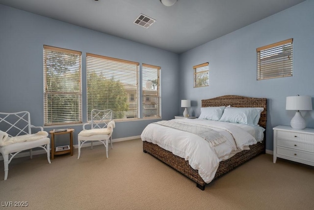 carpeted bedroom featuring visible vents and baseboards