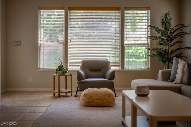 sitting room with light tile patterned floors, plenty of natural light, and baseboards