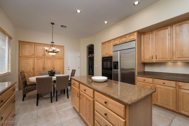 kitchen with arched walkways, visible vents, dark stone countertops, stainless steel built in refrigerator, and recessed lighting