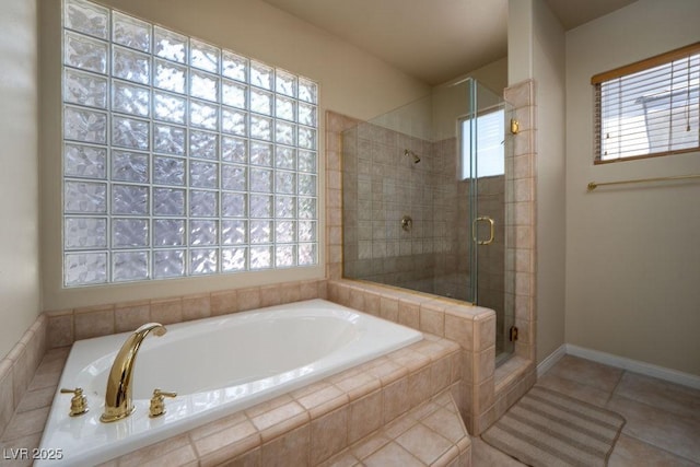 full bathroom featuring a stall shower, baseboards, a garden tub, and tile patterned floors