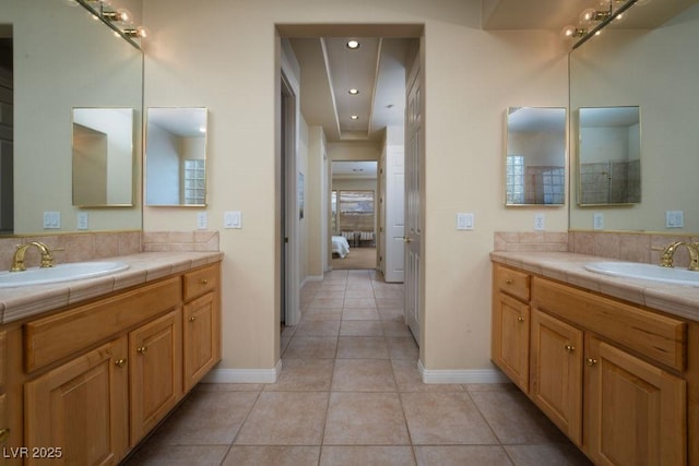 bathroom featuring two vanities, a sink, and tile patterned flooring