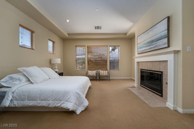 carpeted bedroom with baseboards, multiple windows, and visible vents