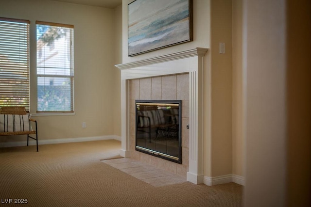 interior space with baseboards, carpet flooring, and a tile fireplace