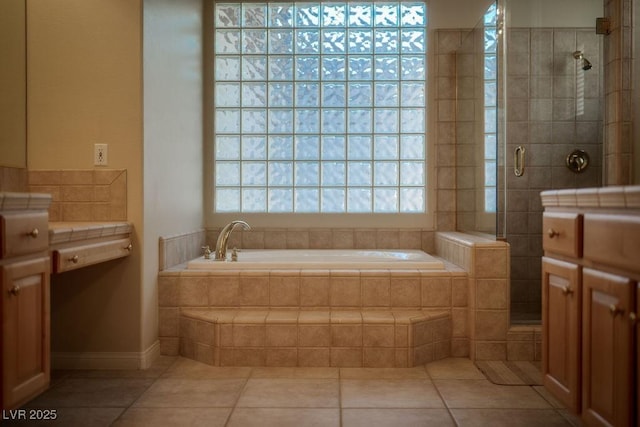 full bathroom featuring a tile shower, a bath, and tile patterned floors