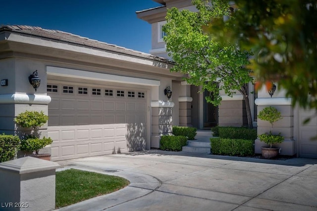 view of front of home with driveway, a garage, and stucco siding