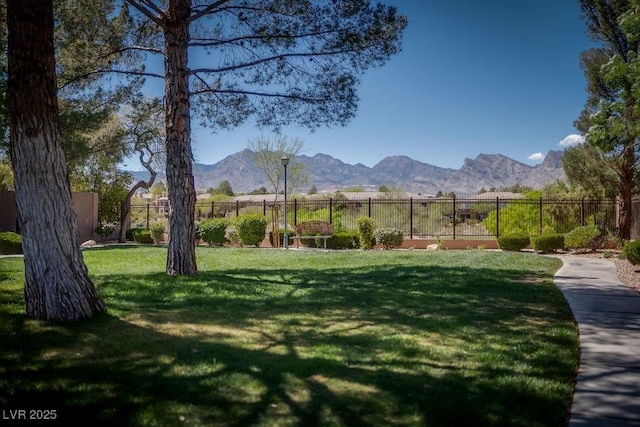 view of yard featuring a mountain view and fence