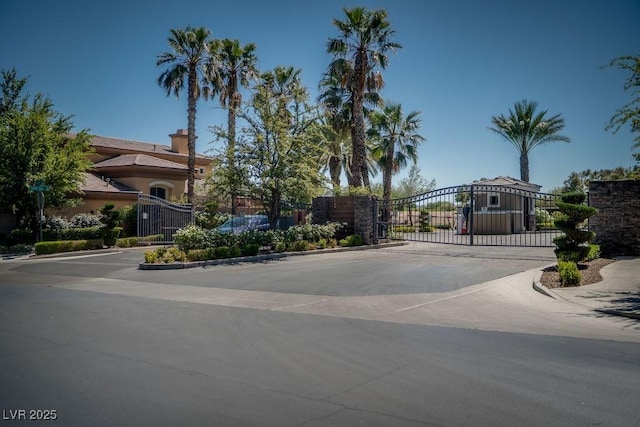 exterior space with a gate, a gated entry, and curbs