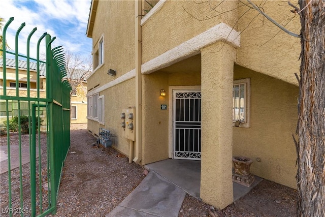 property entrance with stucco siding