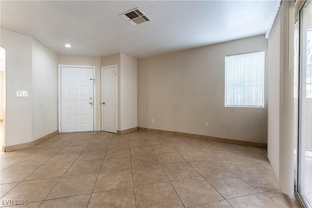 unfurnished room featuring visible vents, baseboards, and light tile patterned floors