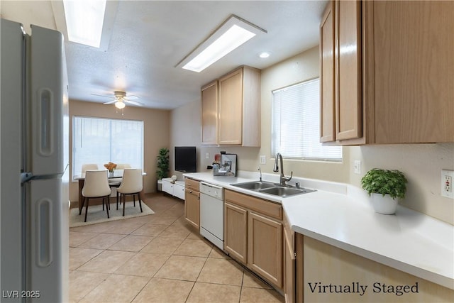 1560 Jamielinn Ln Unit 101, Las Vegas, NV 89110 - kitchen featuring white appliances, a sink, light tile patterned flooring, light countertops, and plenty of natural light