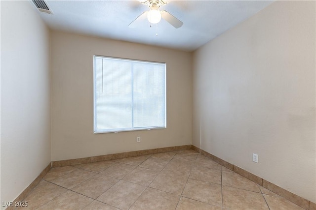 spare room with visible vents, ceiling fan, baseboards, and light tile patterned floors